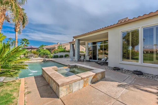 a bedroom with a bed and a large mirror on the dresser