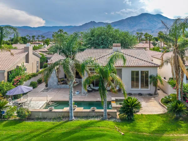 a view of a patio with a table and chairs