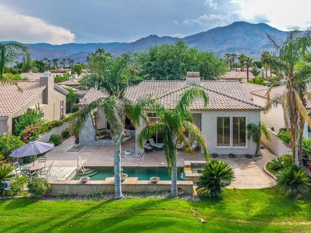 a view of a patio with a table and chairs