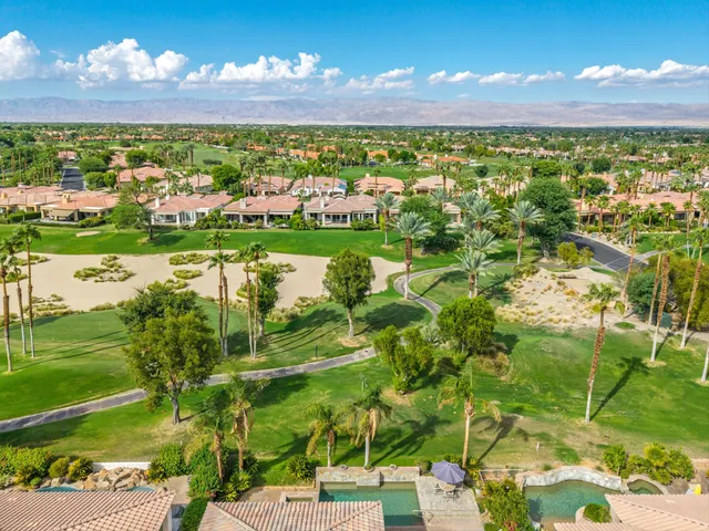 a view of a backyard with a patio table and chairs