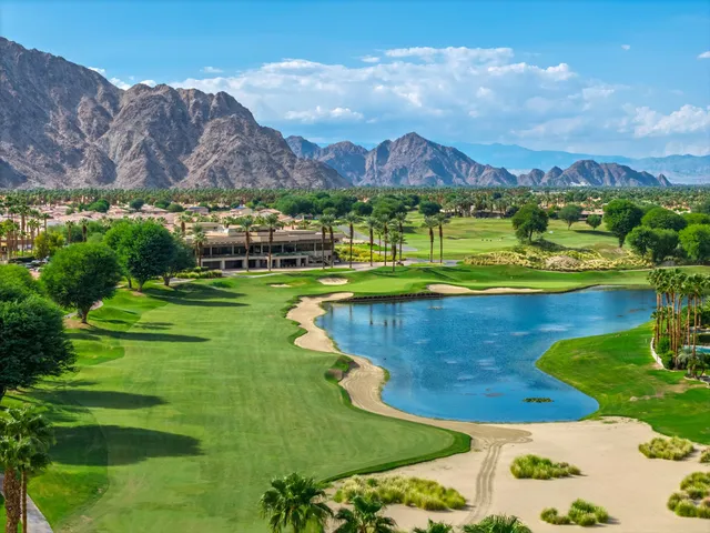 a living room with furniture a floor to ceiling window and a flat screen tv