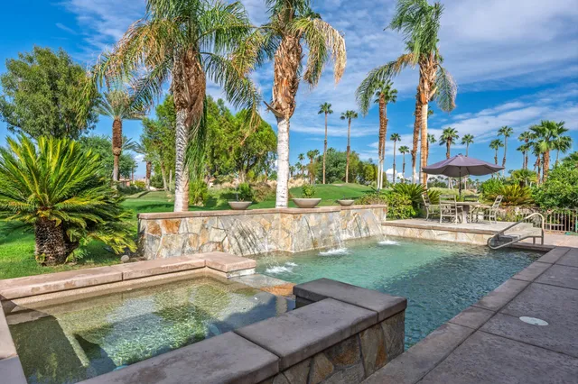 a view of a dining room with furniture and a large window