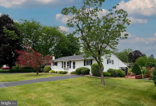 a front view of house with yard and green space