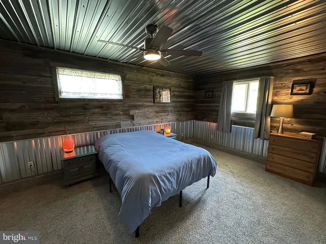 a living room with furniture and a mirror