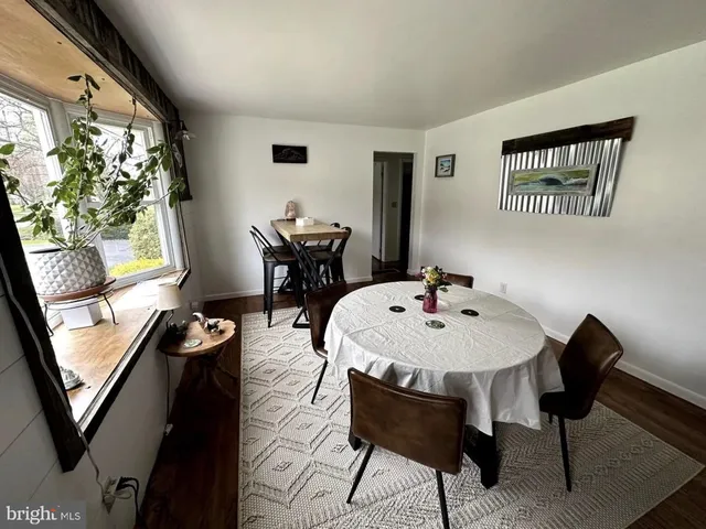a view of a dining room with furniture and a potted plant