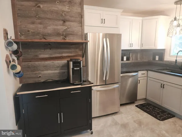 a kitchen with a refrigerator and cabinets