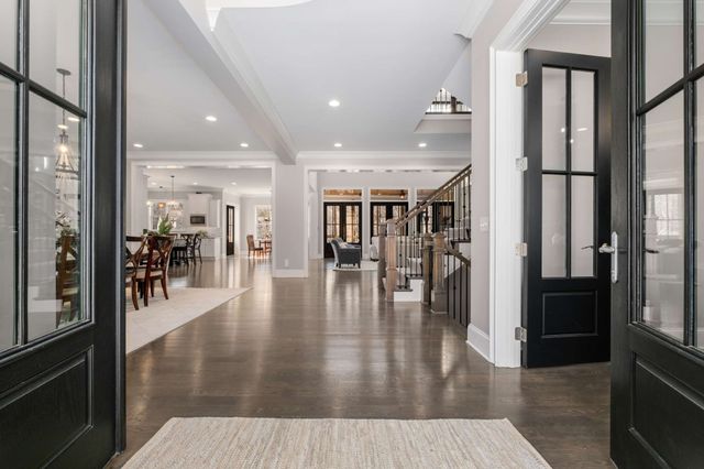 a large kitchen with a table and chairs