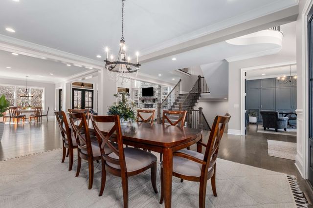 a living room with furniture fireplace and a large window