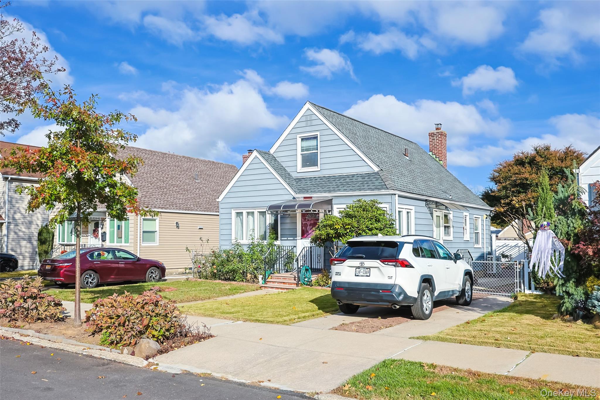 a front view of a house with a garden