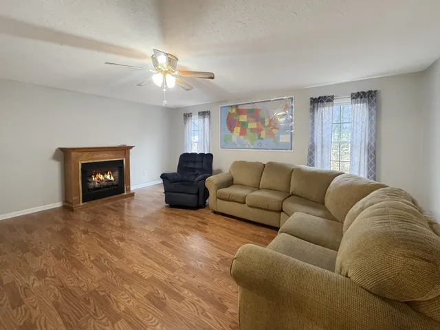 a living room with furniture and a fireplace