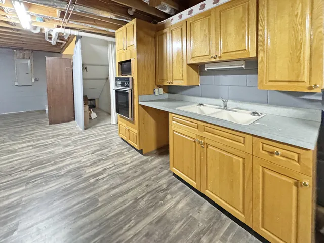 a kitchen with stainless steel appliances granite countertop a sink and cabinets