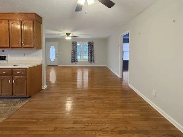 a view of a kitchen with a sink cabinetry and wooden floor