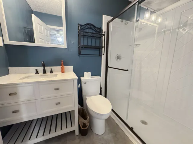 a bathroom with a sink toilet and shower