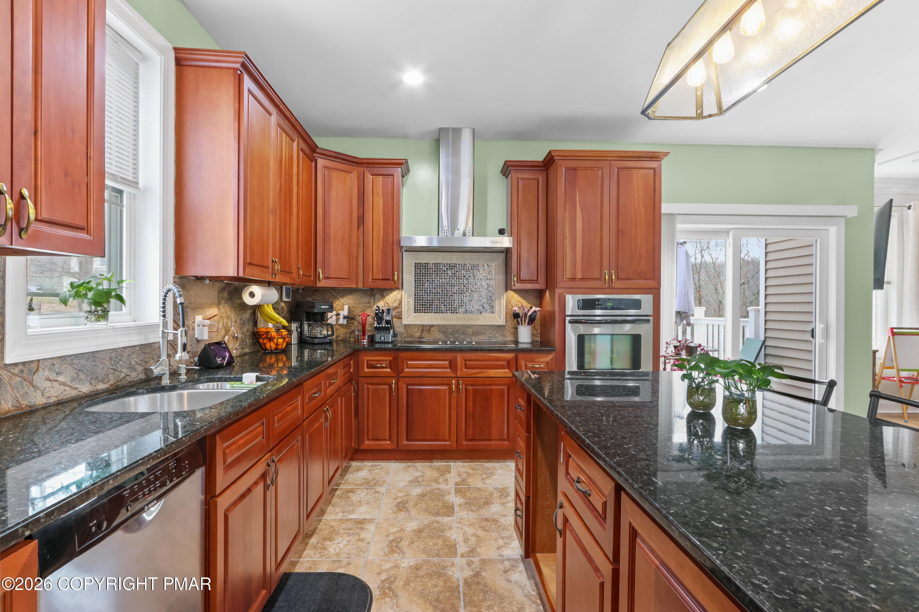 1007 Hampstead Road Bushkill, PA 18324 - Photo 11 of 68 a kitchen with stainless steel appliances granite countertop a sink a stove and a wooden cabinets