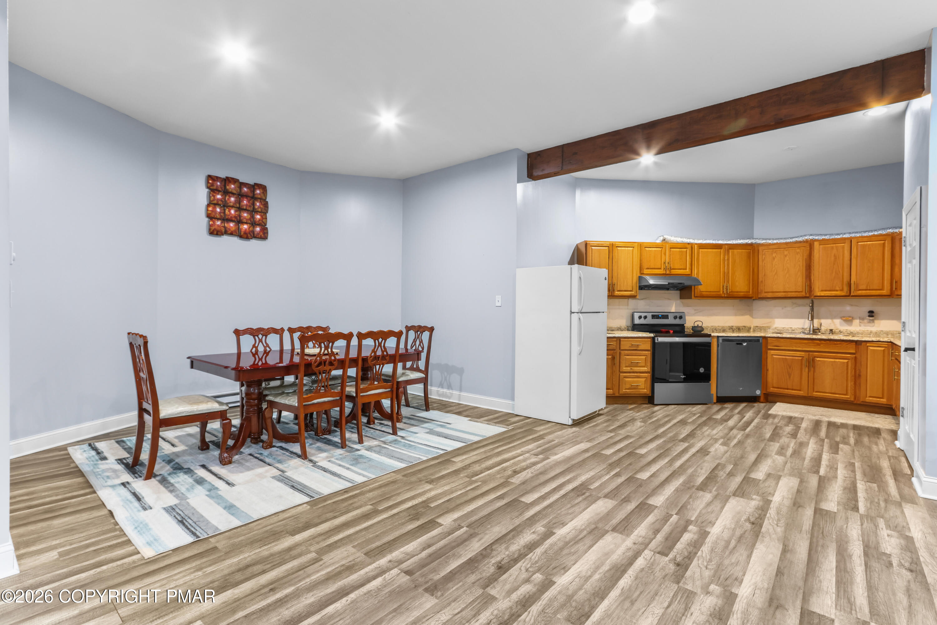 1007 Hampstead Road Bushkill, PA 18324 - Photo 27 of 68 a kitchen with stainless steel appliances a dining table chairs and refrigerator