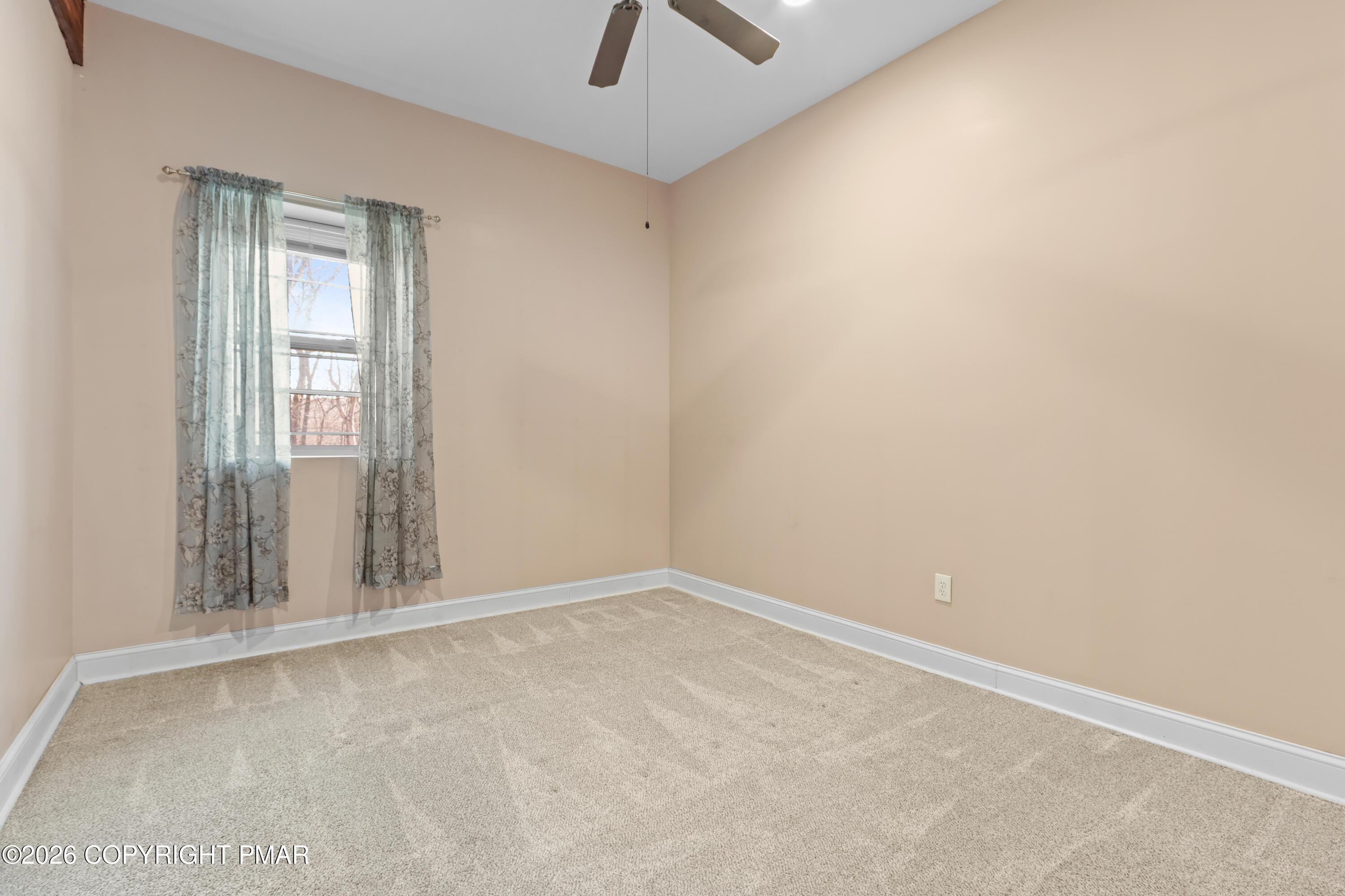 1007 Hampstead Road Bushkill, PA 18324 - Photo 35 of 68 an empty room with a window and ceiling fan