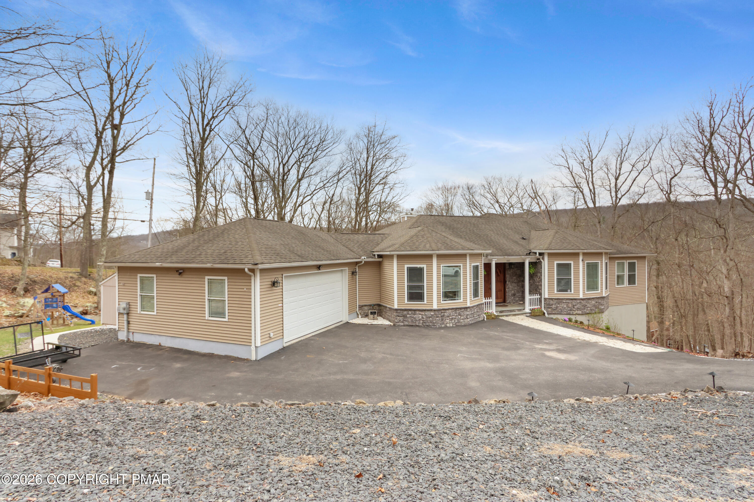 1007 Hampstead Road Bushkill, PA 18324 - Photo 47 of 68 a front view of a house with a yard and garage