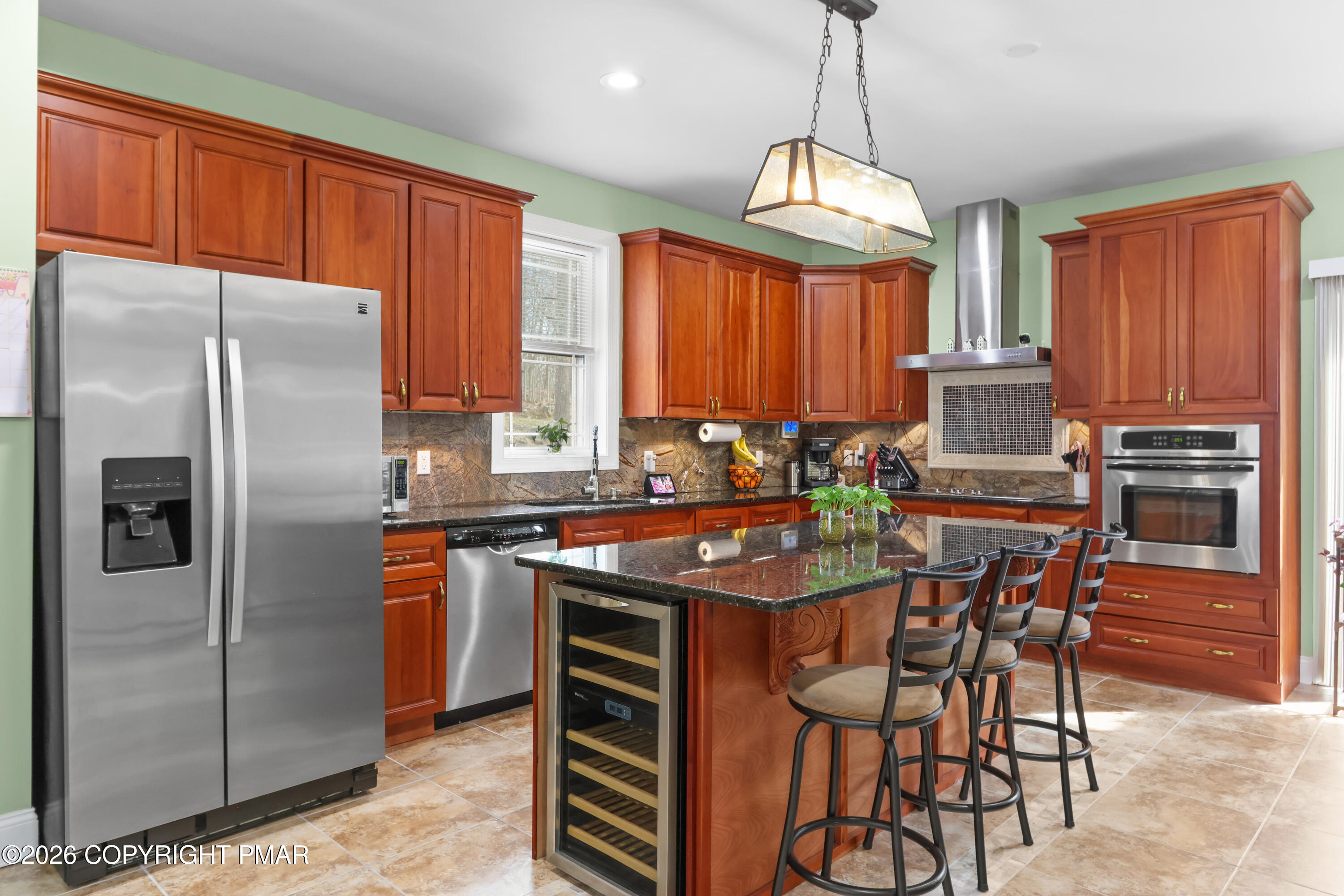 1007 Hampstead Road Bushkill, PA 18324 - Photo 10 of 68 a kitchen with stainless steel appliances granite countertop a stove refrigerator a sink dishwasher and a dining table