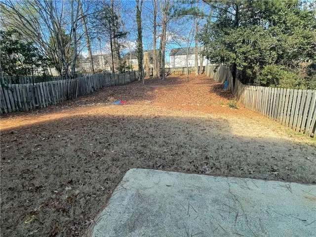 a backyard of a house with a tree