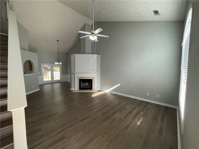 a view of a room with wooden floor and chandelier