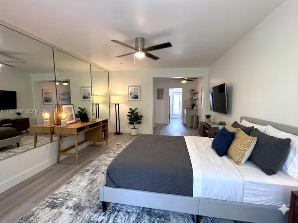 a large bedroom with bed or couch and a flat screen tv
