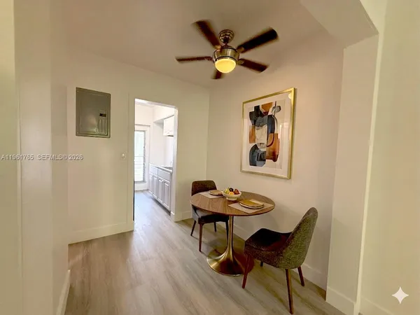 a view of a dining room with furniture and a chandelier fan