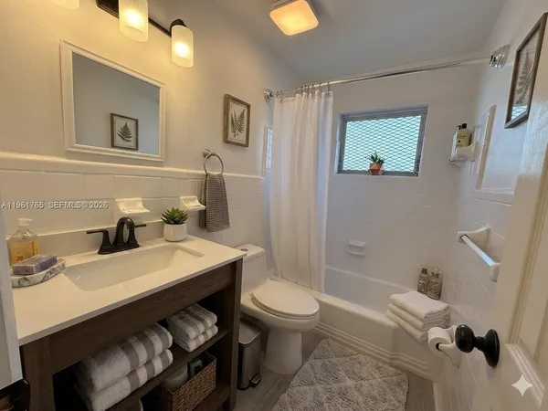 a bathroom with a sink toilet and mirror