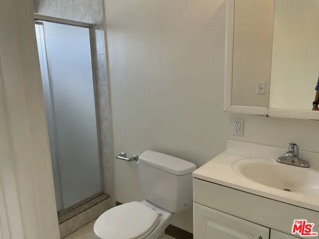 a white toilet sitting next to a bathroom sink