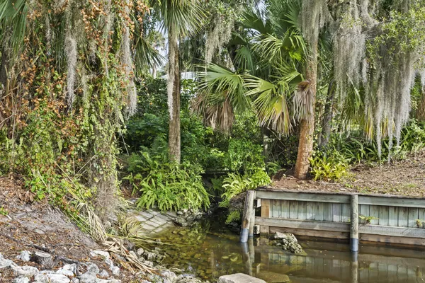a view of house with swimming pool and sitting area