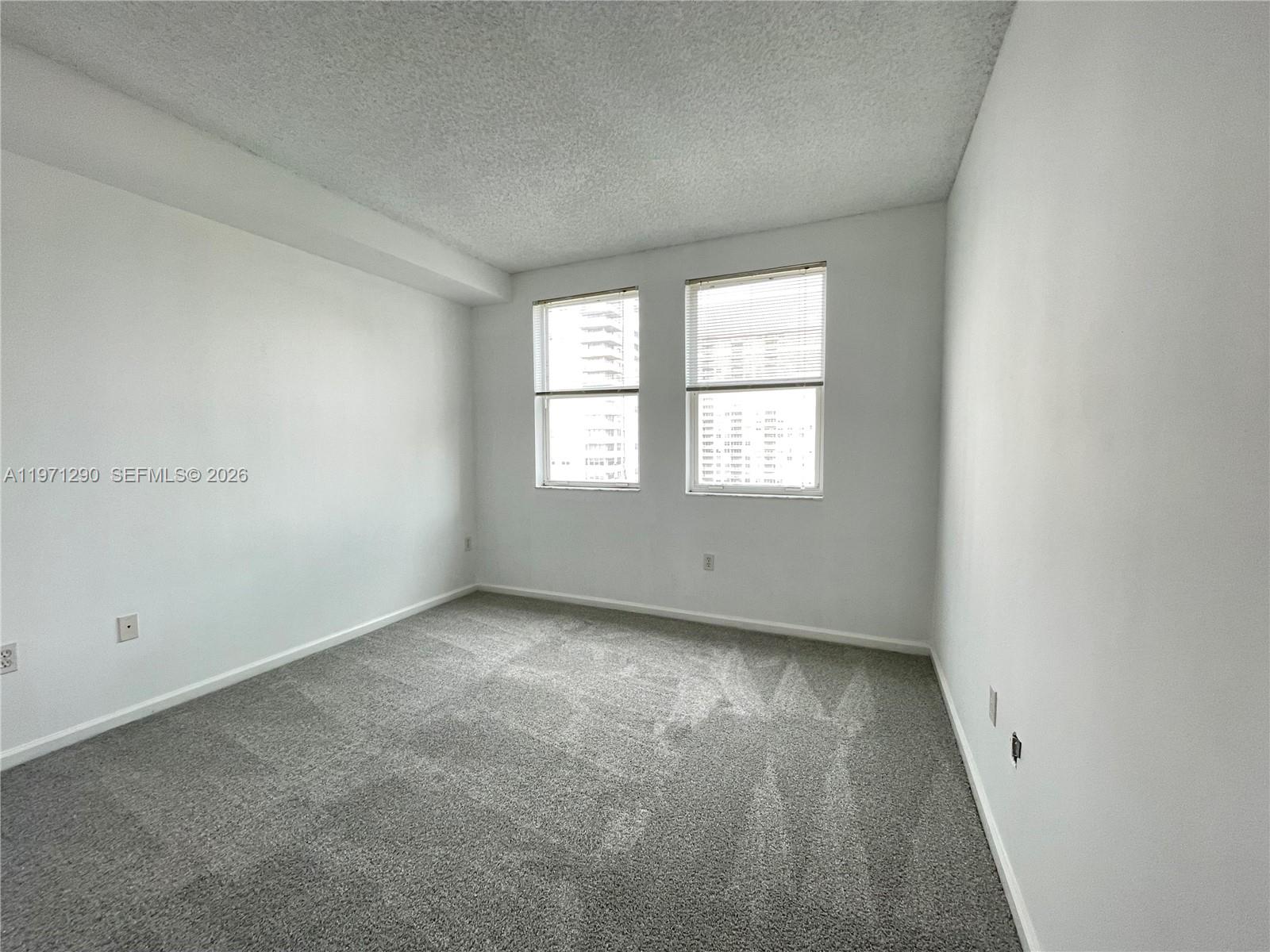 17150 North Bay Road, Unit 2911 Sunny Isles Beach, FL 33160 - Photo 11 of 43 an empty room with windows