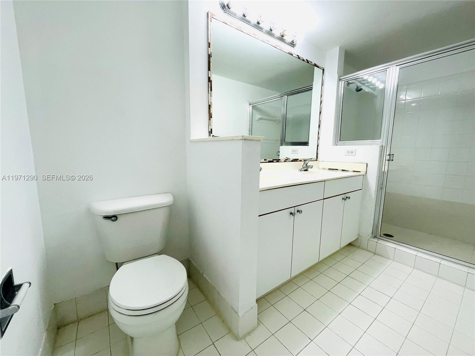 17150 North Bay Road, Unit 2911 Sunny Isles Beach, FL 33160 - Photo 14 of 43 a bathroom with a sink toilet and mirror