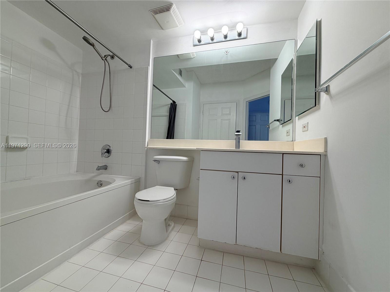 17150 North Bay Road, Unit 2911 Sunny Isles Beach, FL 33160 - Photo 32 of 43 a bathroom with a sink a toilet a mirror a vanity and bathtub