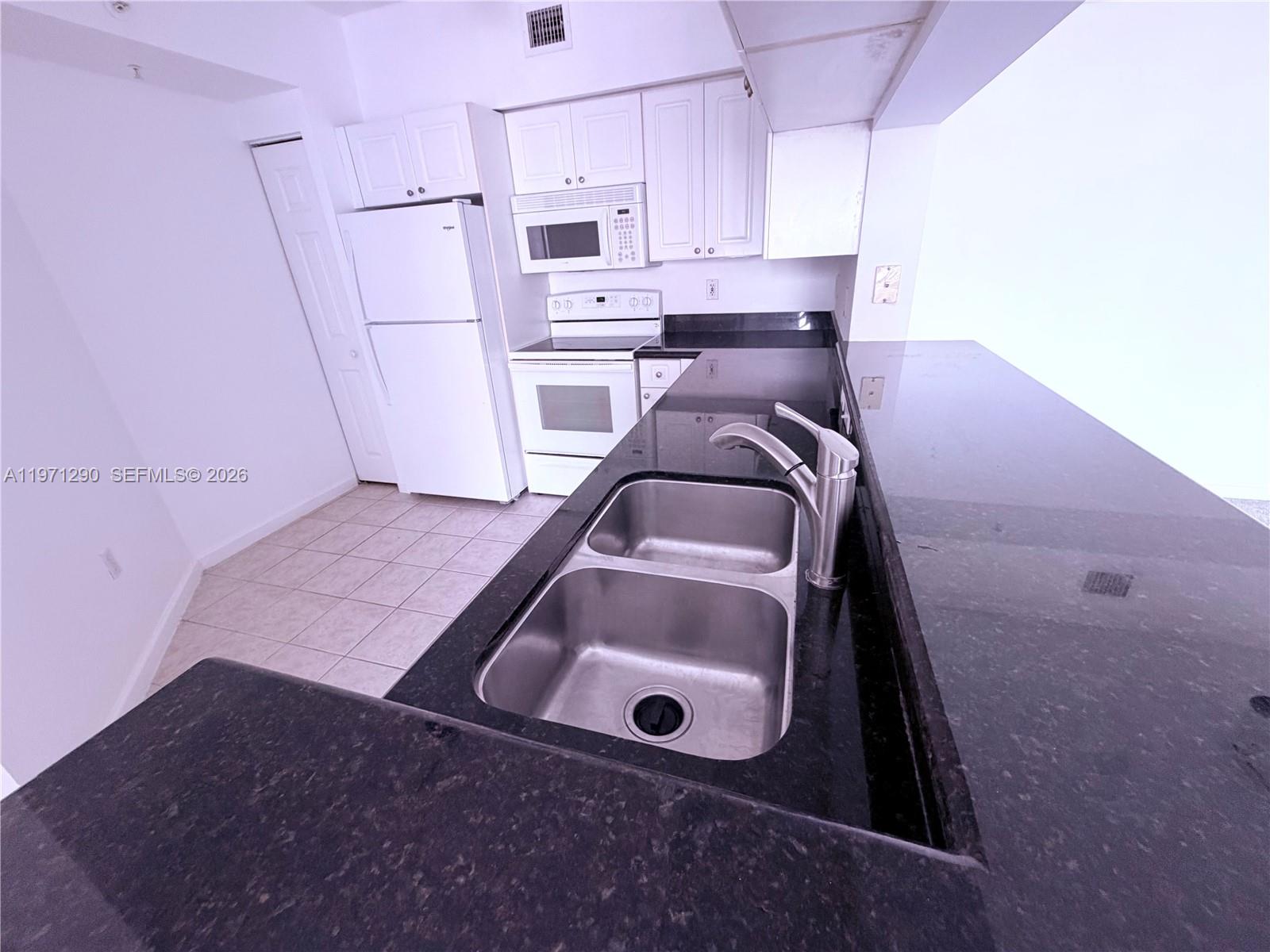 17150 North Bay Road, Unit 2911 Sunny Isles Beach, FL 33160 - Photo 5 of 43 a view of kitchen and sink