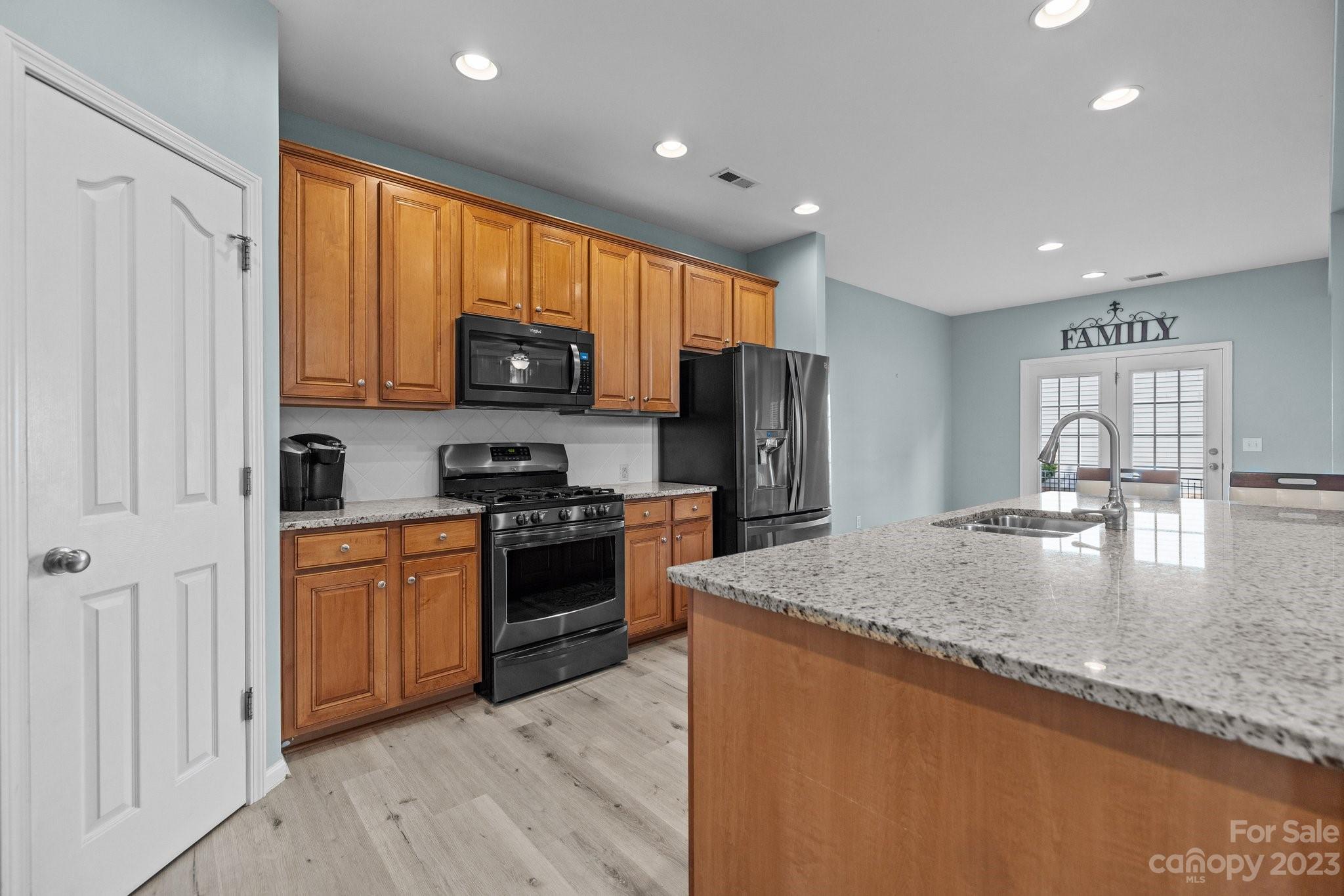 309 Ayers Road Fort Mill, SC 29715 - Photo 11 of 38 a kitchen with stainless steel appliances granite countertop a refrigerator a stove top oven a sink and dishwasher