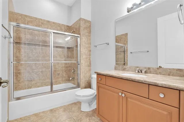 an empty room with chandelier fan