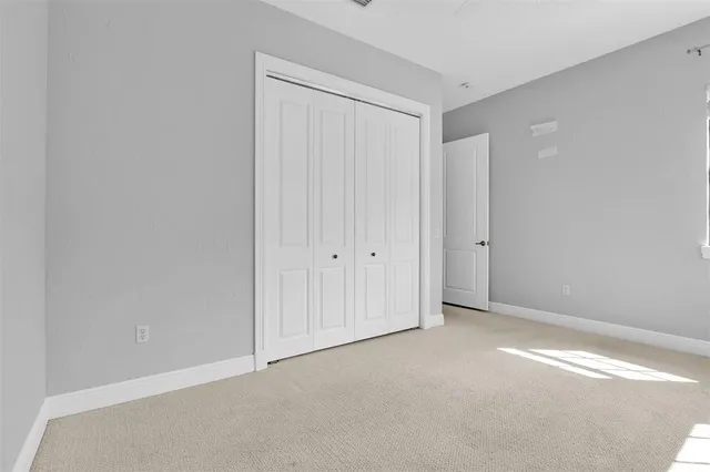 a kitchen with stainless steel appliances granite countertop a refrigerator a sink dishwasher a oven and a dining table with wooden floor