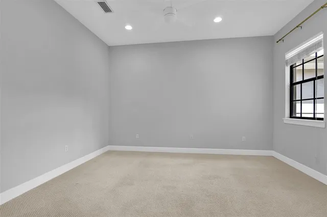 a view of a kitchen with a refrigerator a sink and a window