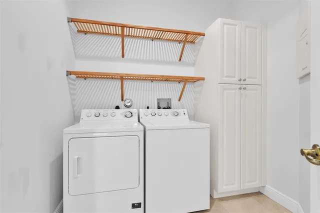 a kitchen with refrigerator a sink dishwasher a oven with a dining table and chairs