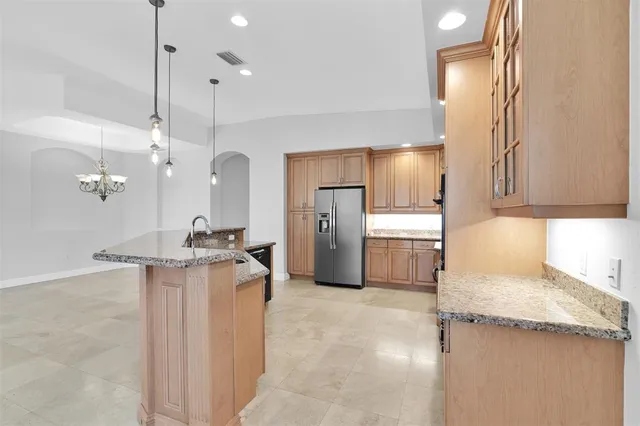 a view of a kitchen with refrigerator and a sink