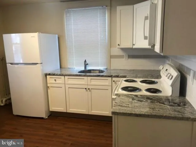 a kitchen with stainless steel appliances a stove a sink and a refrigerator