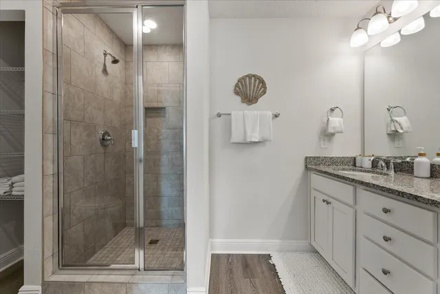 a bathroom with a shower sink and mirror