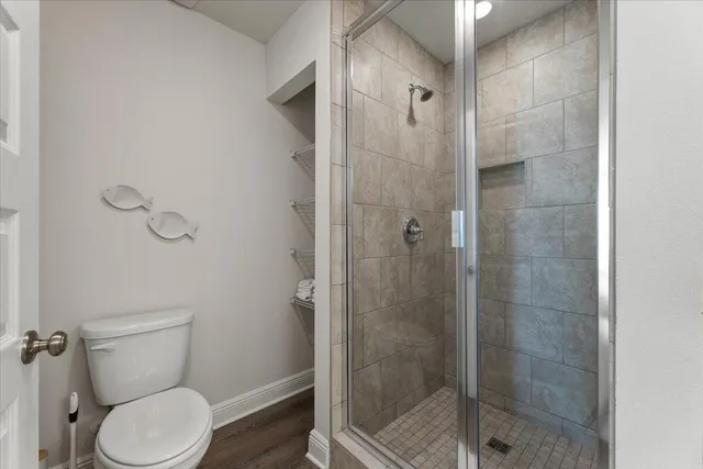 a bathroom with a toilet and shower
