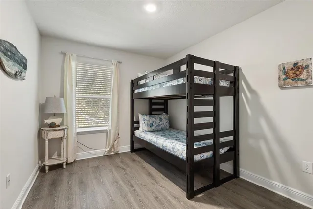 a bedroom with furniture and wooden floor
