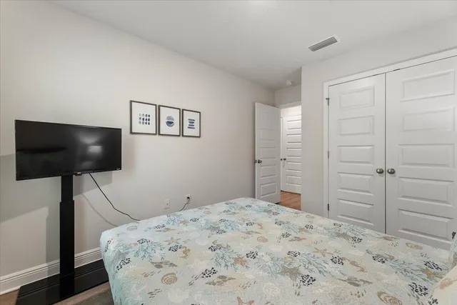 a bedroom with a bed and a flat screen tv
