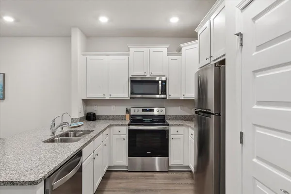 a kitchen with a sink stove and refrigerator
