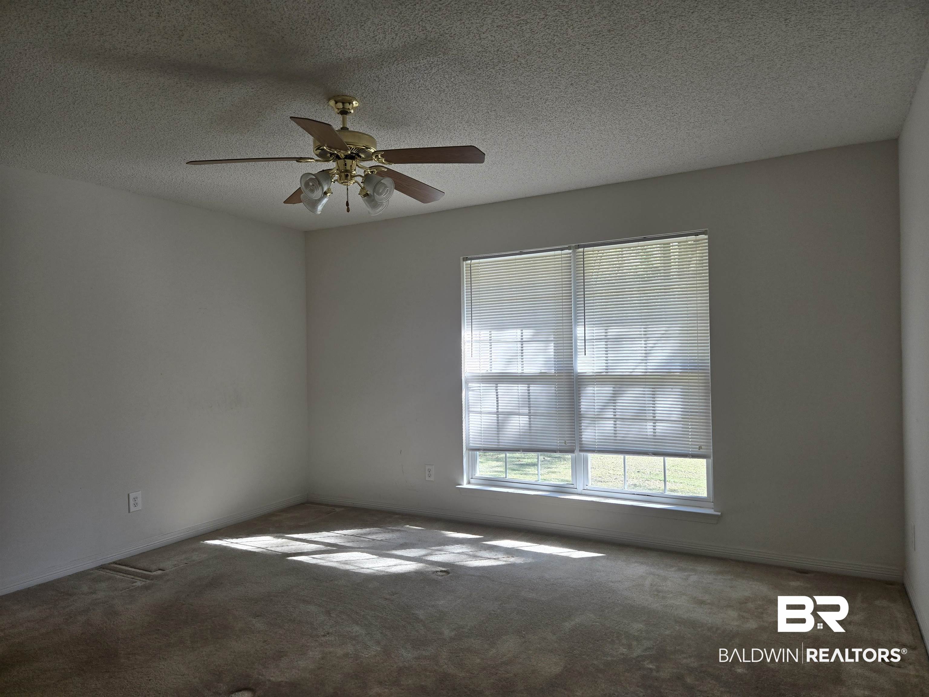 2554 Riverside Drive Mobile, AL 36605 - Photo 18 of 43 Carpeted spare room with a textured ceiling and ceiling fan