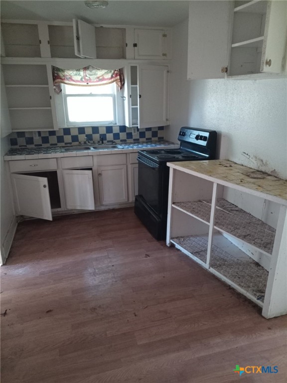1214 South 19th Street Temple, TX 76504 - Photo 6 of 11 a kitchen with stainless steel appliances granite countertop a stove a sink and white cabinets
