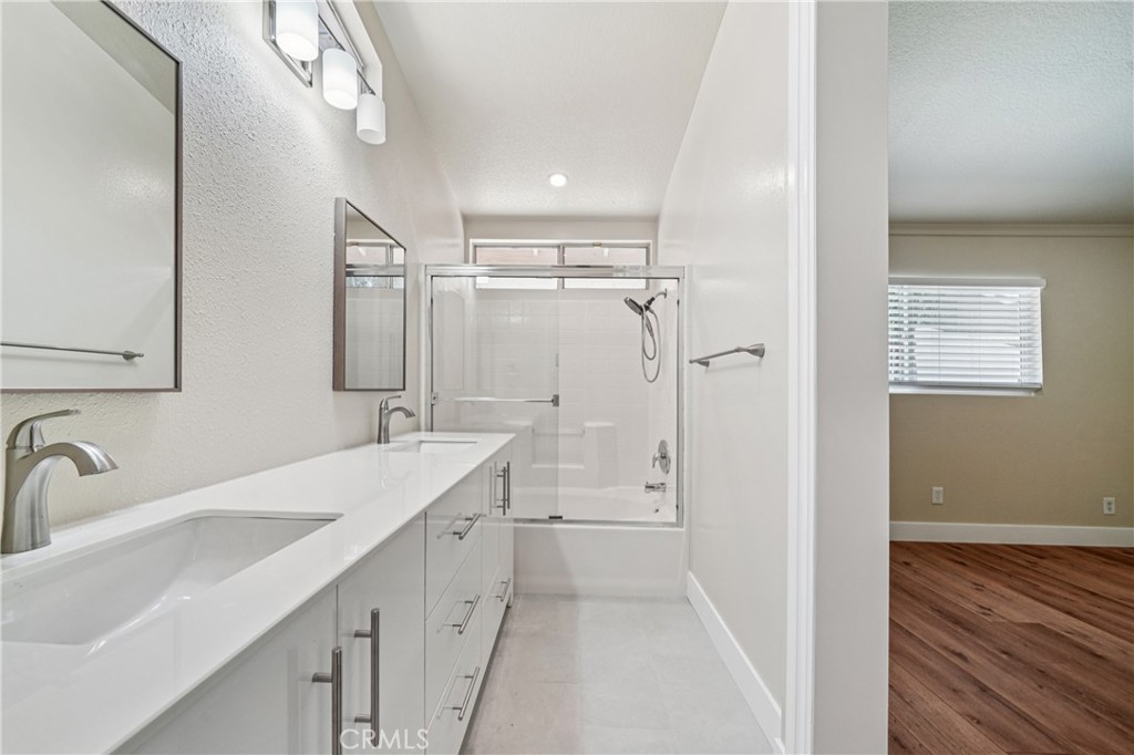 7271 Venosa Place Rancho Cucamonga, CA 91701 - Photo 18 of 32 a bathroom with a sink a toilet a mirror and shower