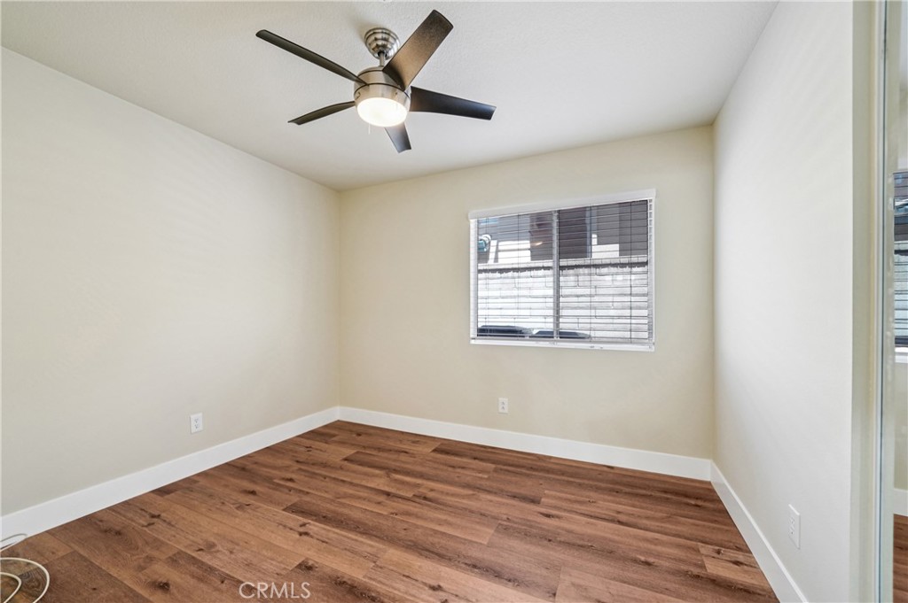 7271 Venosa Place Rancho Cucamonga, CA 91701 - Photo 20 of 32 an empty room with wooden floor and windows