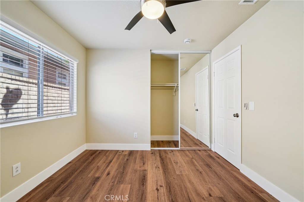 7271 Venosa Place Rancho Cucamonga, CA 91701 - Photo 22 of 32 a view of empty room with wooden floor and window